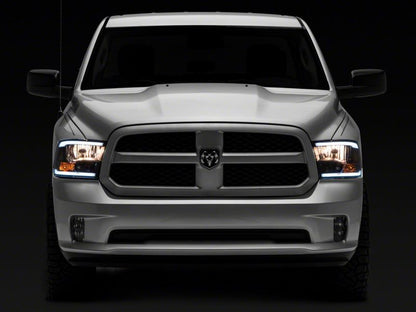 Raxiom 09-18 Dodge RAM 1500/2500/3500 Axial Series Headlights w/ LED Bar- Blk Housing (Clear Lens)